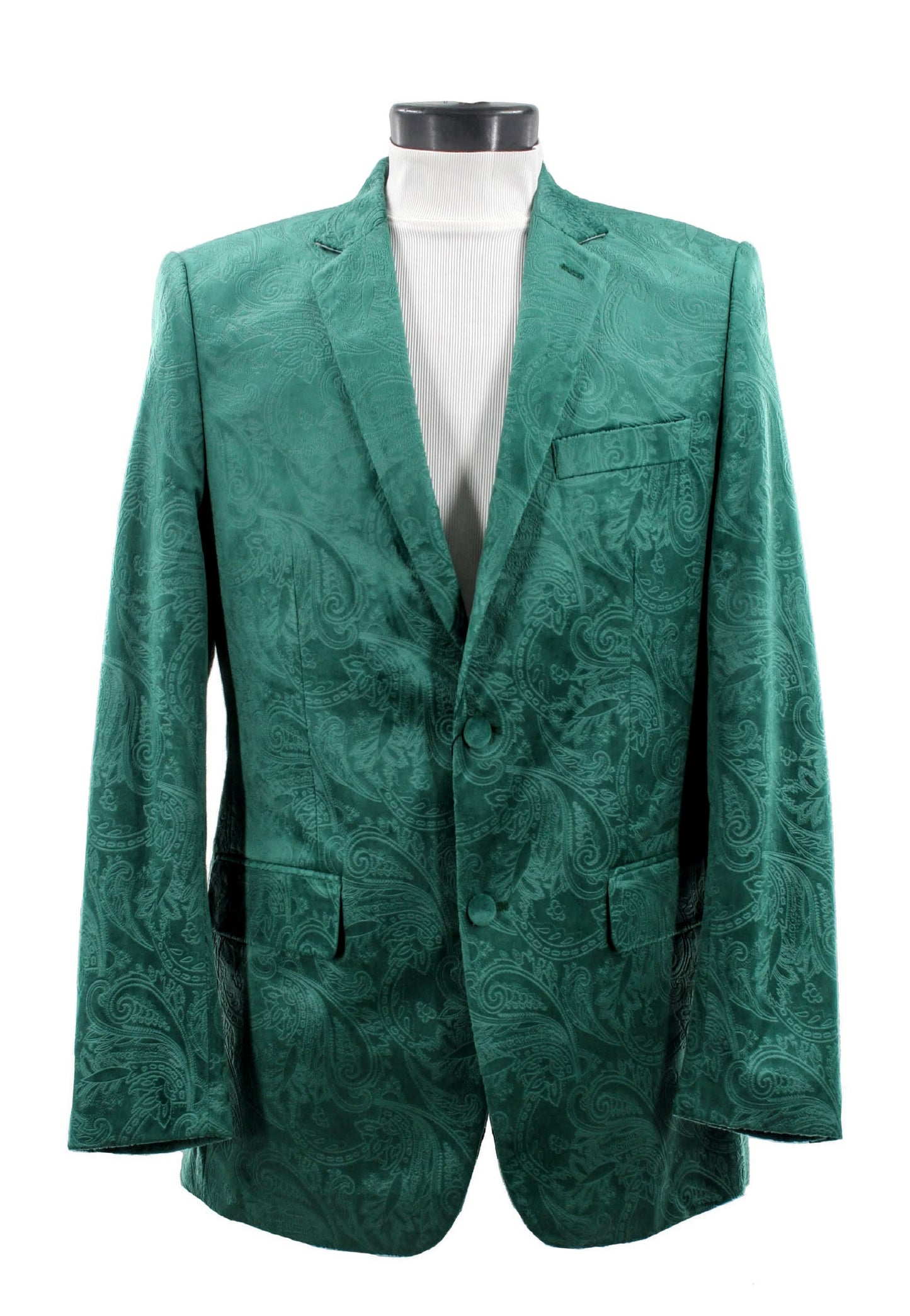 The Bassiri Blazer J1044-H Green, featuring a green paisley design, drapes elegantly over the mannequin to reveal a chic white turtleneck underneath.