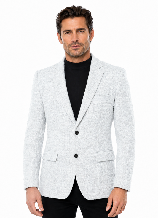 The Bassiri Blazer J1045-White by Bassiri features a textured white fabric, two buttons, notched lapels, and front flap pockets, shown on a black mannequin torso.