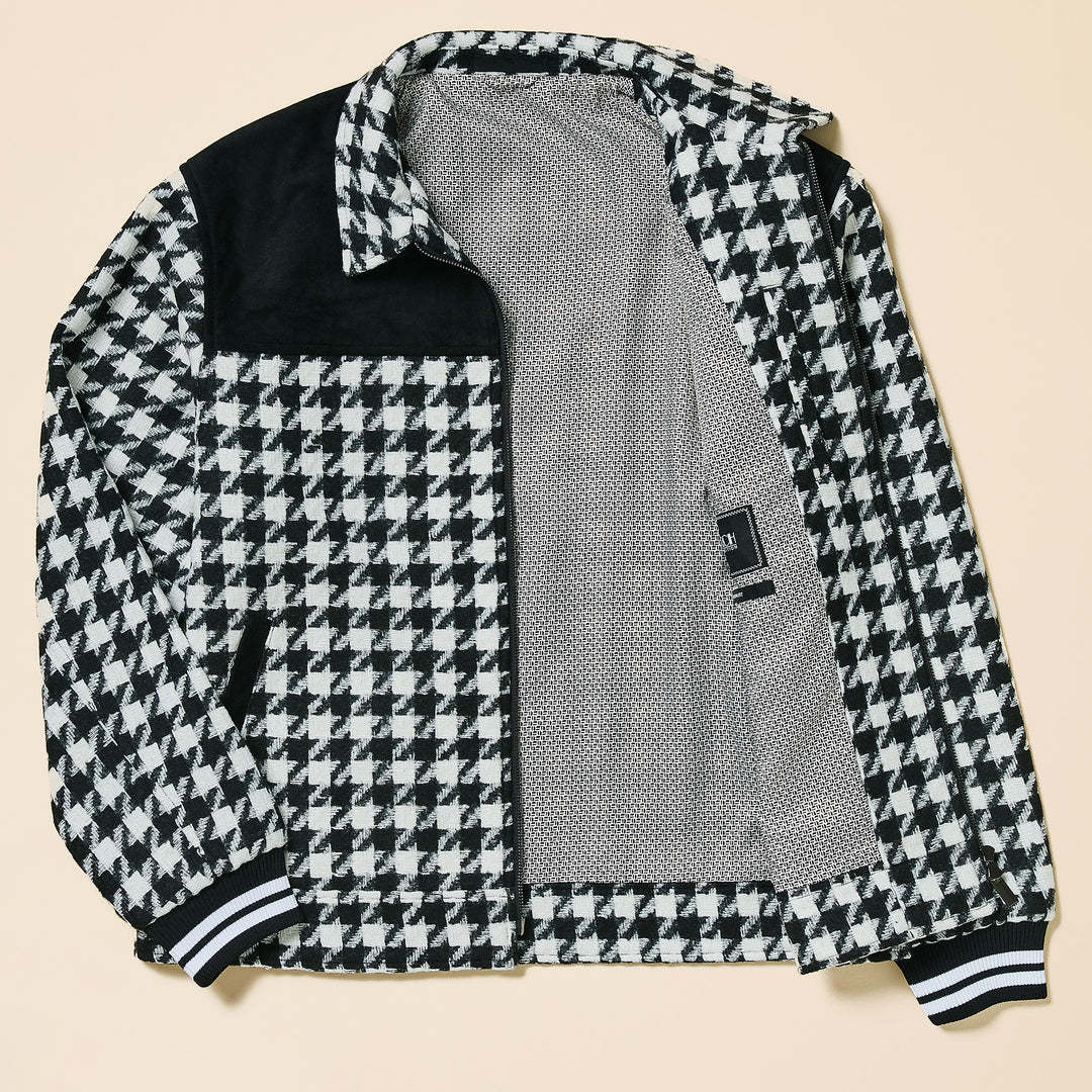 A man wears the Inserch Wool Blend Houndstooth Full Zip Bomber Jacket JS264-41 Black/White with black details, a red shirt, and blue jeans, standing against a plain beige background.