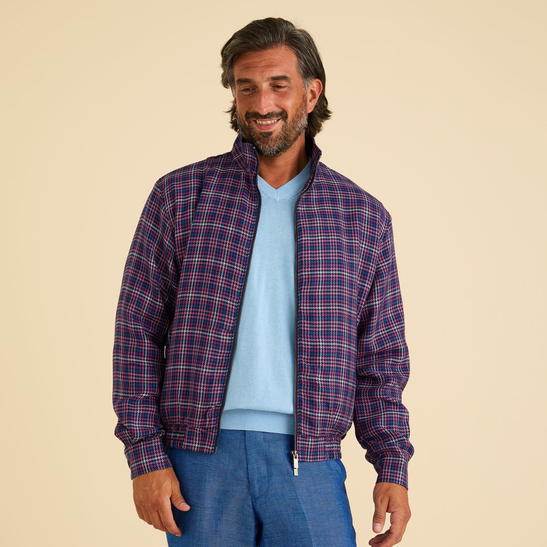 A man stands against a beige background wearing the Inserch Micro Check Full Zip Jacket JS266-126 Purple by Inserch, styled over a light blue sweater and blue pants.