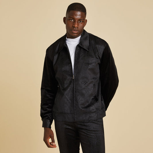 A man wears the Inserch Sueded Snake Skin Embossed Jacket Suit JS268-01 Black over a white t-shirt, standing against a plain beige background.