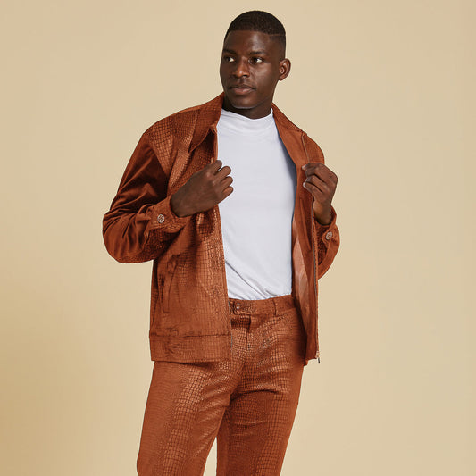 A man wears the Inserch Sueded Snake Skin Embossed Jacket Suit JS268-104 in Cognac over a plain white t-shirt, posing against a beige background.