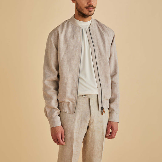 A man wears the Inserch Linen Bomber Jacket JS660-00006 Oatmeal by Inserch, paired with matching pants and a white shirt, standing against a plain beige background.