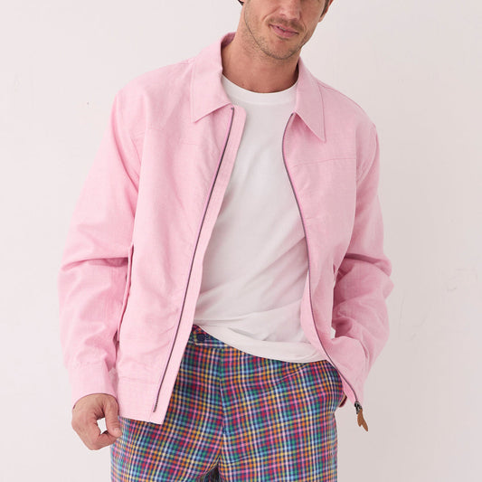 A man wearing an Inserch Linen Harrington Jacket JS661-00193 in Desert Rose and colorful plaid pants stands against a plain white background.
