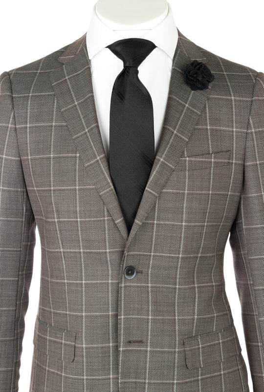 The Canaletto Porto Slim Fit Taupe Gray Windowpane Pure Wool Suit by GUABELLO Cloth (LG8878F/435/3) is shown with a black tie, white dress shirt, and black lapel pin on a headless mannequin—a modern luxury men's look.