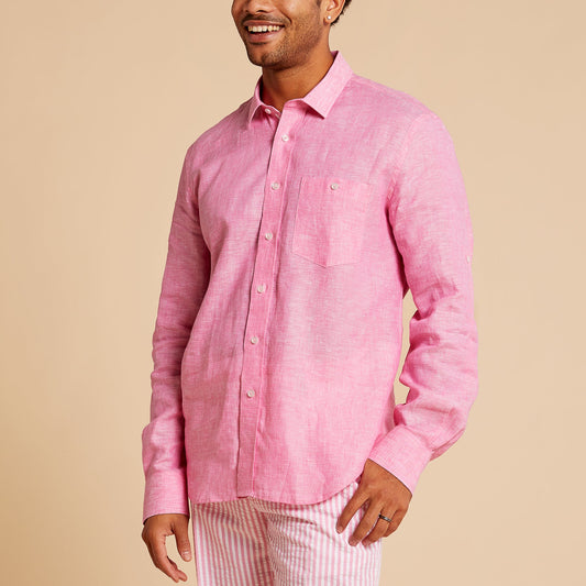 Man wearing the Inserch Linen Long-Sleeve Shirt LS29116-00057 in Summer Pink, paired with pink-and-white striped pants, standing and smiling against a beige background.