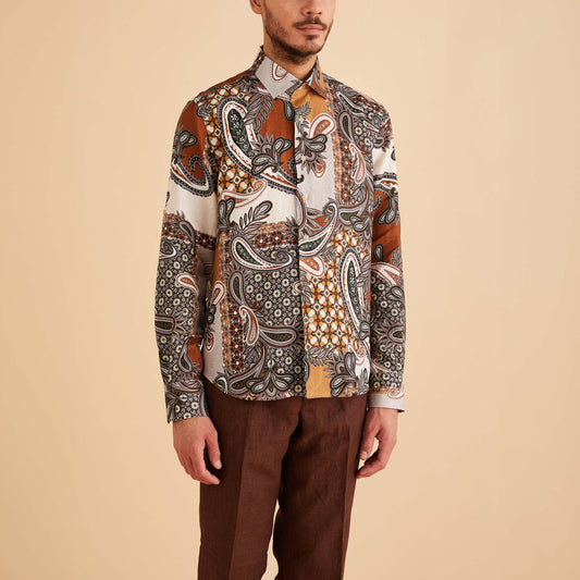 A man in an Inserch LS Mediterranean Paisley Print Linen Shirt (Mocha, LS2919-00064) and brown pants stands against a beige backdrop.