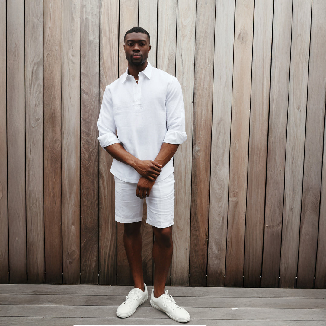 A man in an Inserch LS Linen Pull Over Shirt (White) stands against a plain beige background, exuding effortless elegance.