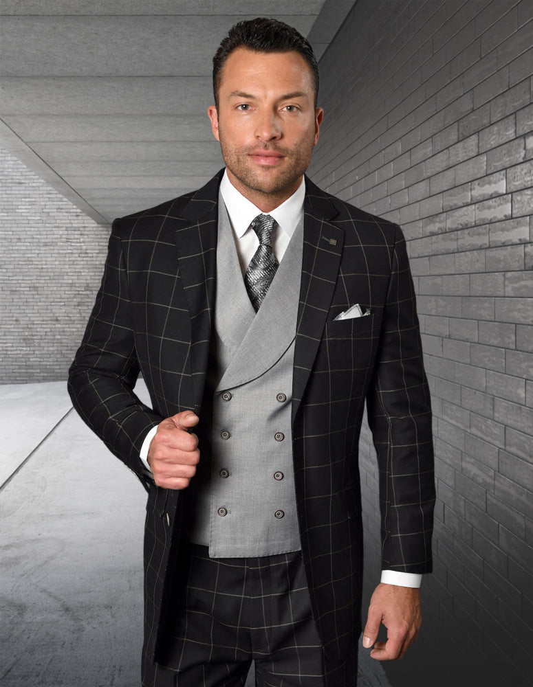 A man wearing the Statement Clothing LUCCA-BLACK-GRAY modern fit black plaid suit jacket with a light gray double-breasted vest, white shirt, patterned tie, and pocket square stands before a modern brick wall.