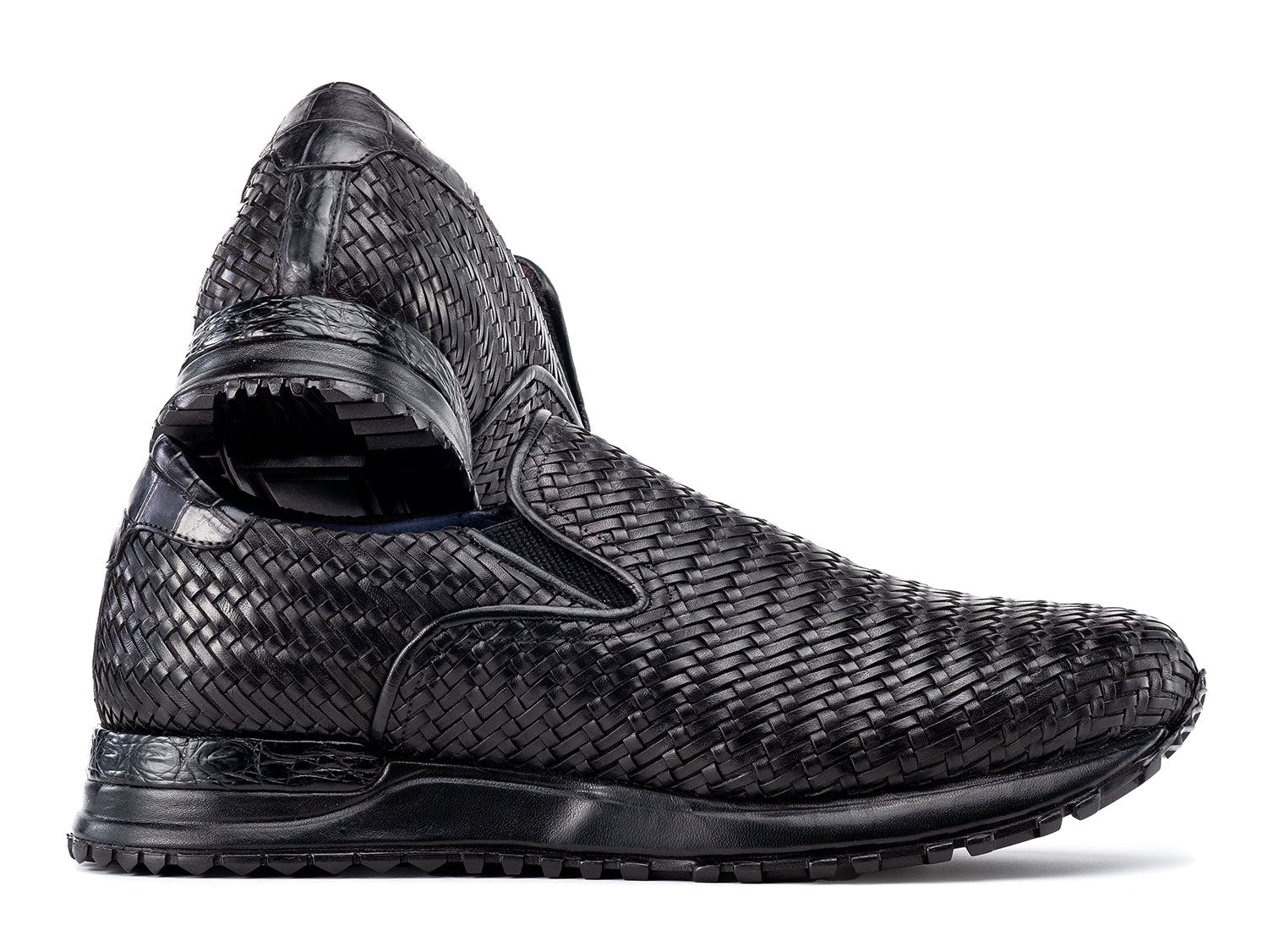 Paul Parkman Men's Black Woven Leather Slip-On Sneakers (LW204BLK) are shown against a white background, featuring stylish textured soles with one shoe resting atop the other.