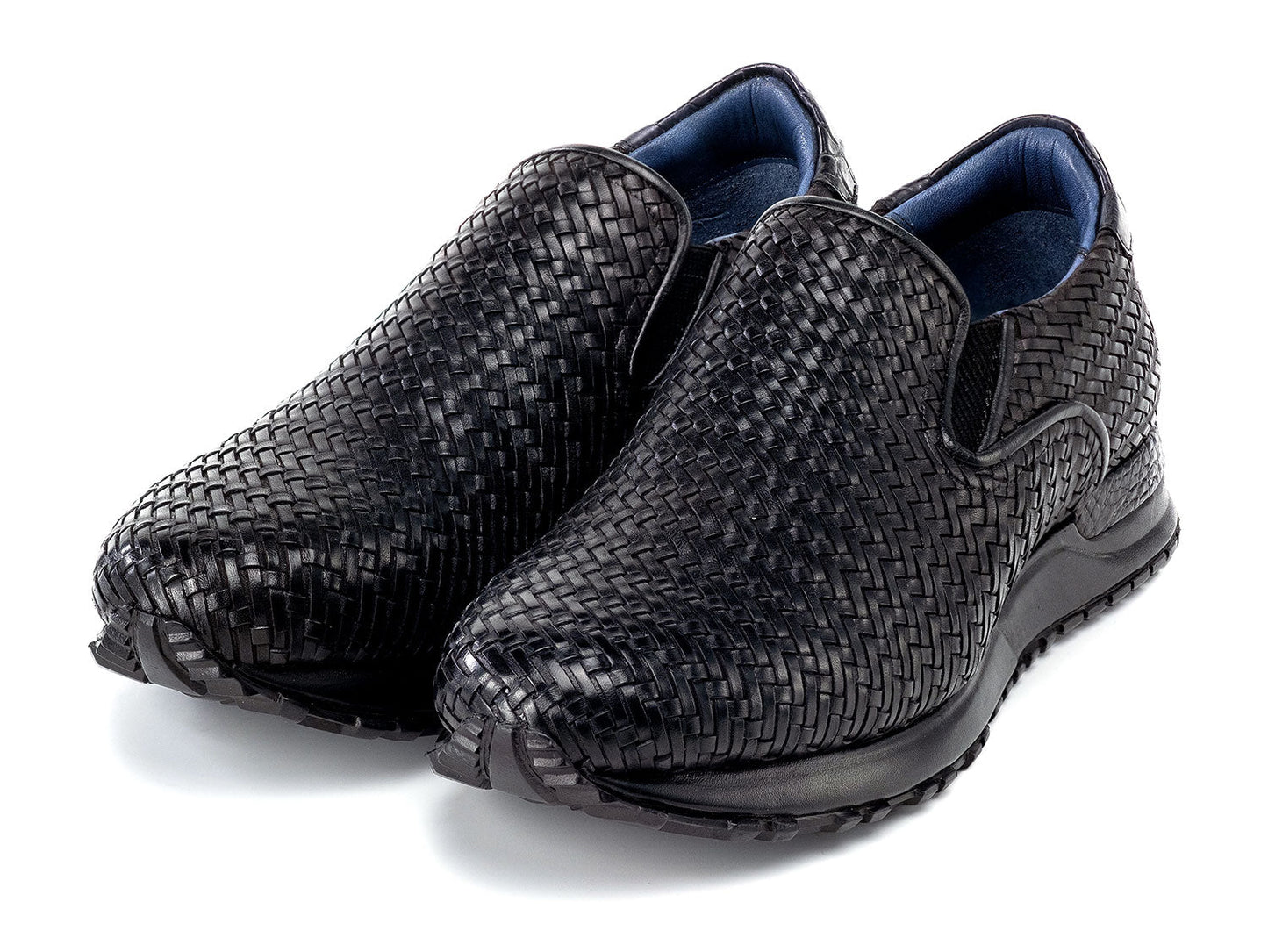 Paul Parkman Men's Black Woven Leather Slip-On Sneakers (LW204BLK) are shown against a white background, featuring stylish textured soles with one shoe resting atop the other.