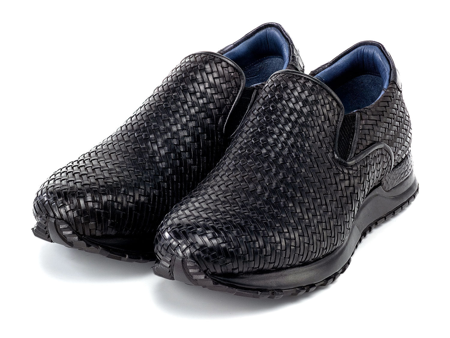 Paul Parkman Men's Black Woven Leather Slip-On Sneakers (LW204BLK) are shown against a white background, featuring stylish textured soles with one shoe resting atop the other.
