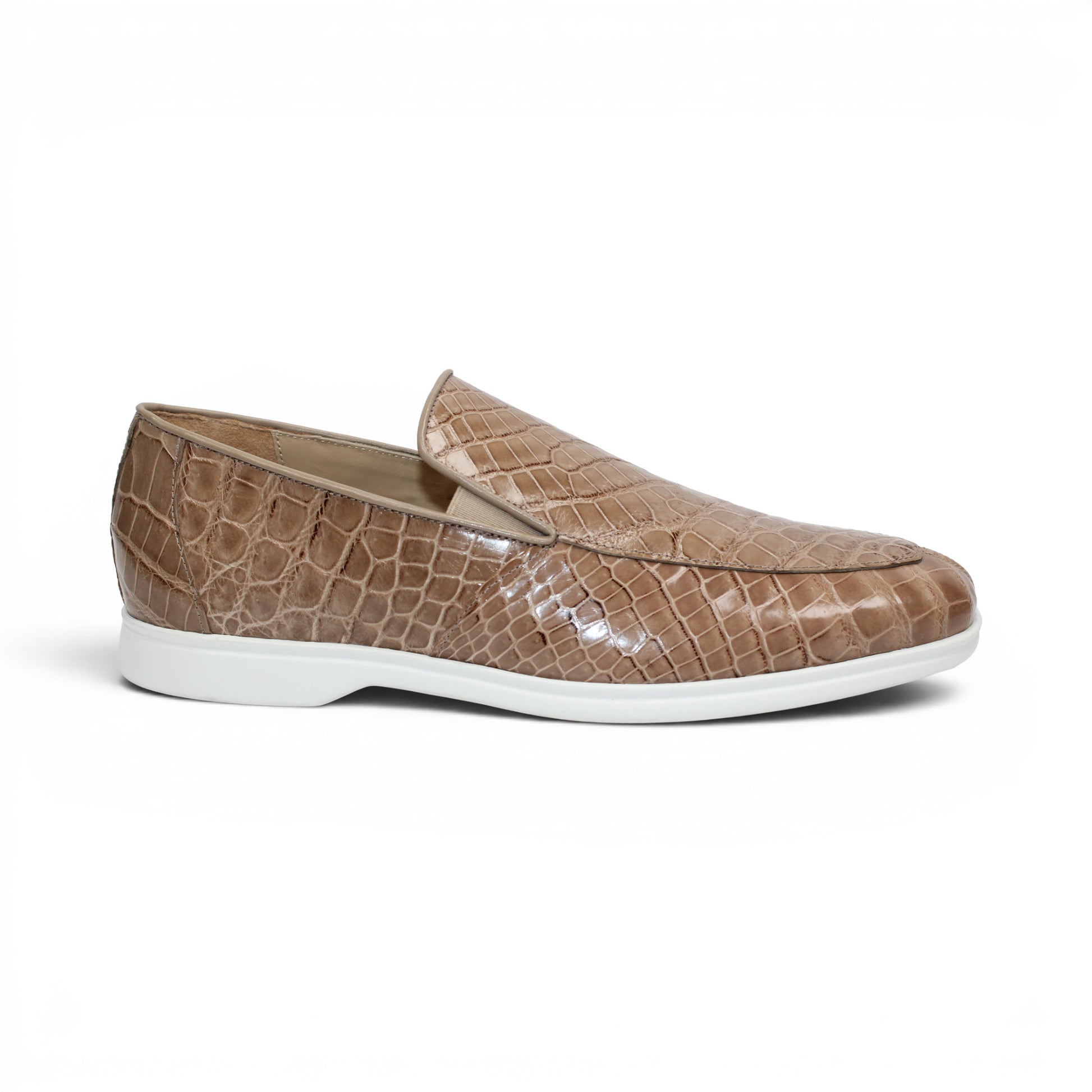 The Fennix Lance Taupe by Fennix of Italy, a taupe crocodile-patterned loafer with a crisp white sole, is displayed in profile against a white background—an exquisite example of luxury men's footwear.