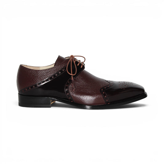 An Emilio Franco Luciano Burgundy oxford shoe, crafted from premium leather in a rich burgundy shade, features laces, classic wingtip detailing, and a polished finish on the toe and side panels, displayed in profile against a white background.