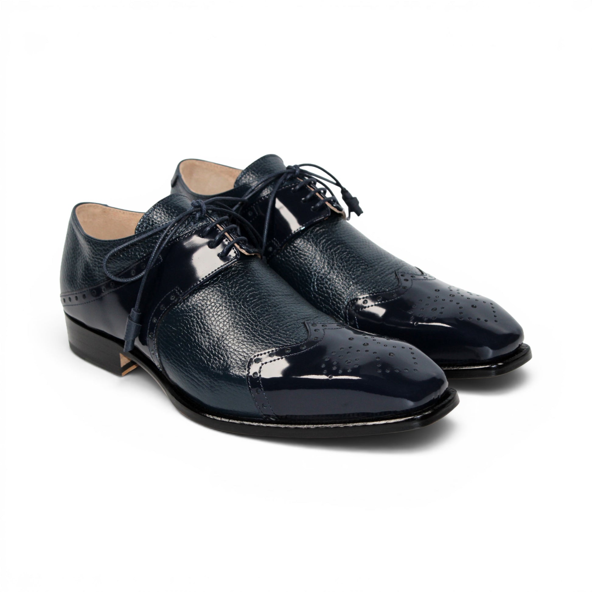 The Emilio Franco Luciano Navy by Emilio Franco is a luxury men's shoe in dark blue Italian leather, featuring brogue detailing, laces, and a low black heel, displayed on a white background.