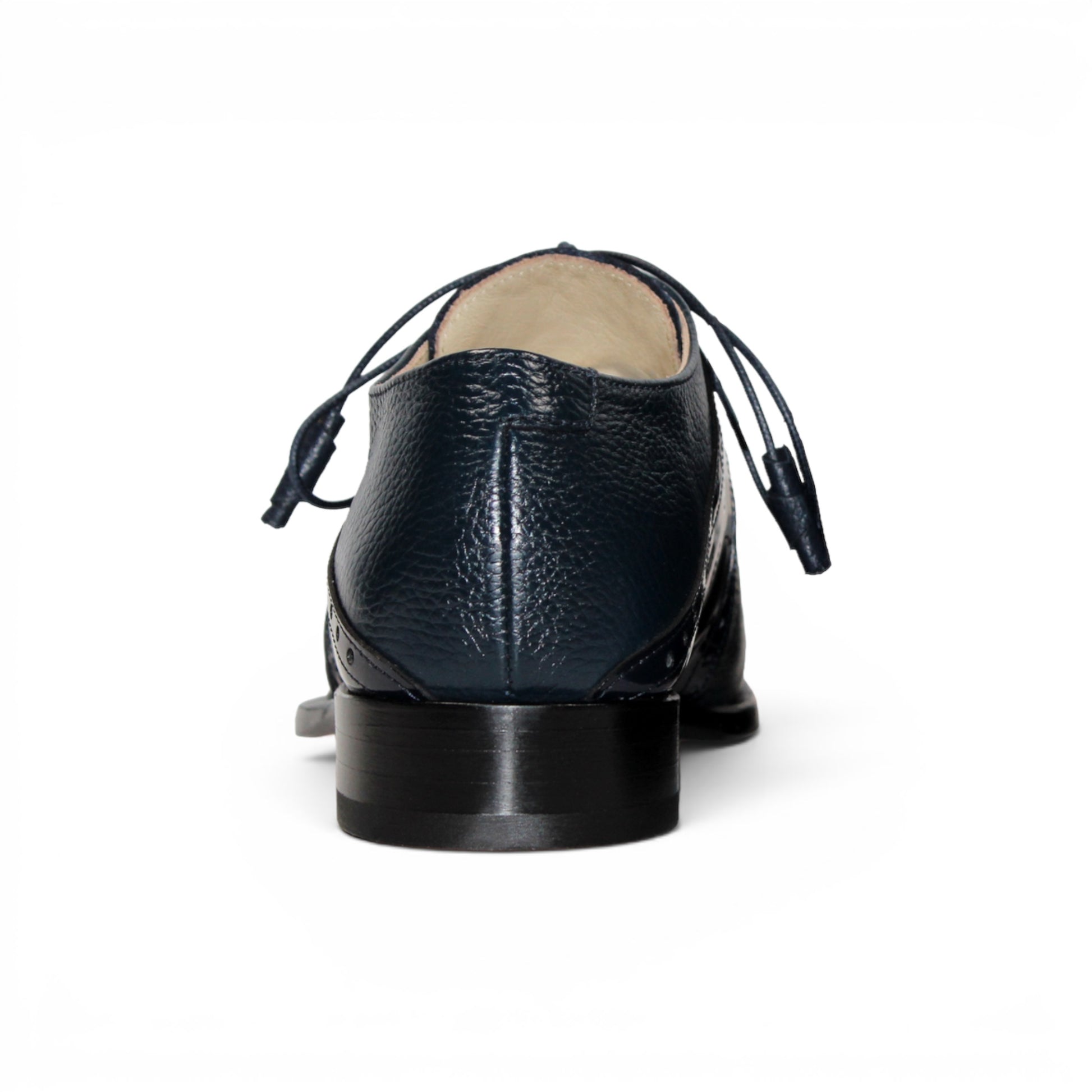 The Emilio Franco Luciano Navy by Emilio Franco is a luxury men's shoe in dark blue Italian leather, featuring brogue detailing, laces, and a low black heel, displayed on a white background.