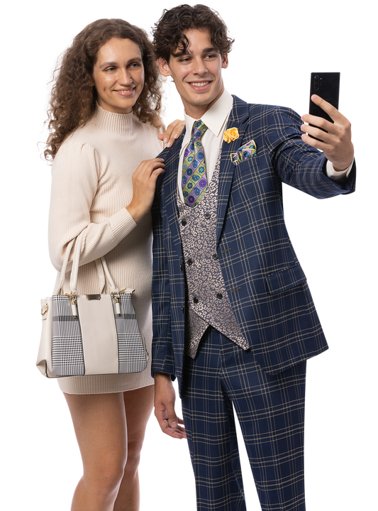 A woman in a light dress stands beside a man wearing the EJ Samuel Blue Suit M2814 by EJ SAMUEL and a fancy vest as he takes a selfie with his smartphone.
