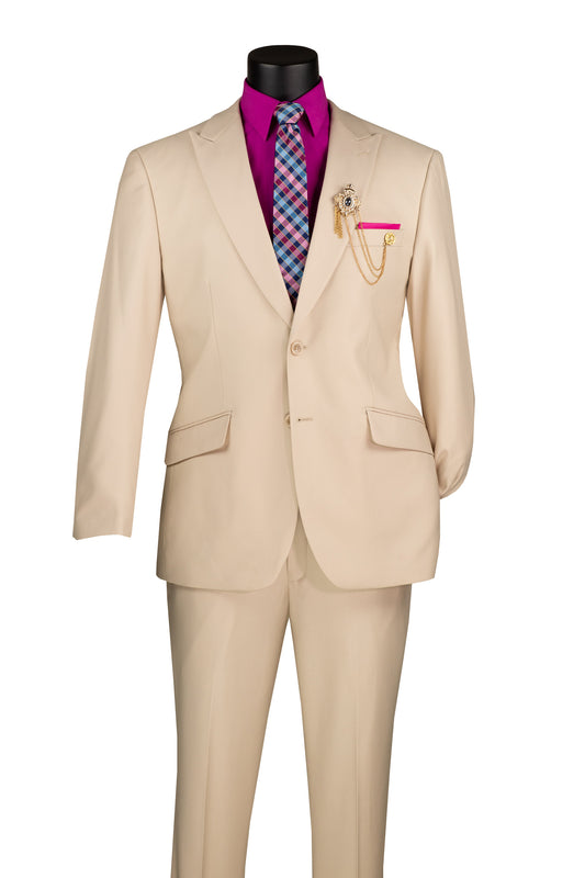 The Vinci Suits Modern Fit Suit features a peak lapel sand M2TR blazer and pants with a single-button closure. Paired elegantly with a magenta shirt, multicolored checkered tie, decorative brooch, and chain add charm to the textured ensemble.