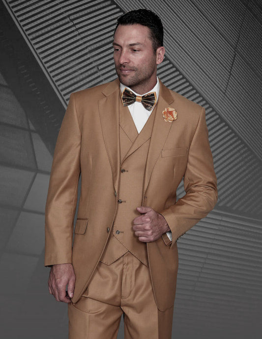 A man in the STATEMENT CLOTHING | MESSINA-CARAMEL tan wool three-piece suit by Statement Clothing, featuring pleated pants, a matching bow tie, and a flower lapel pin, stands against a geometric background.