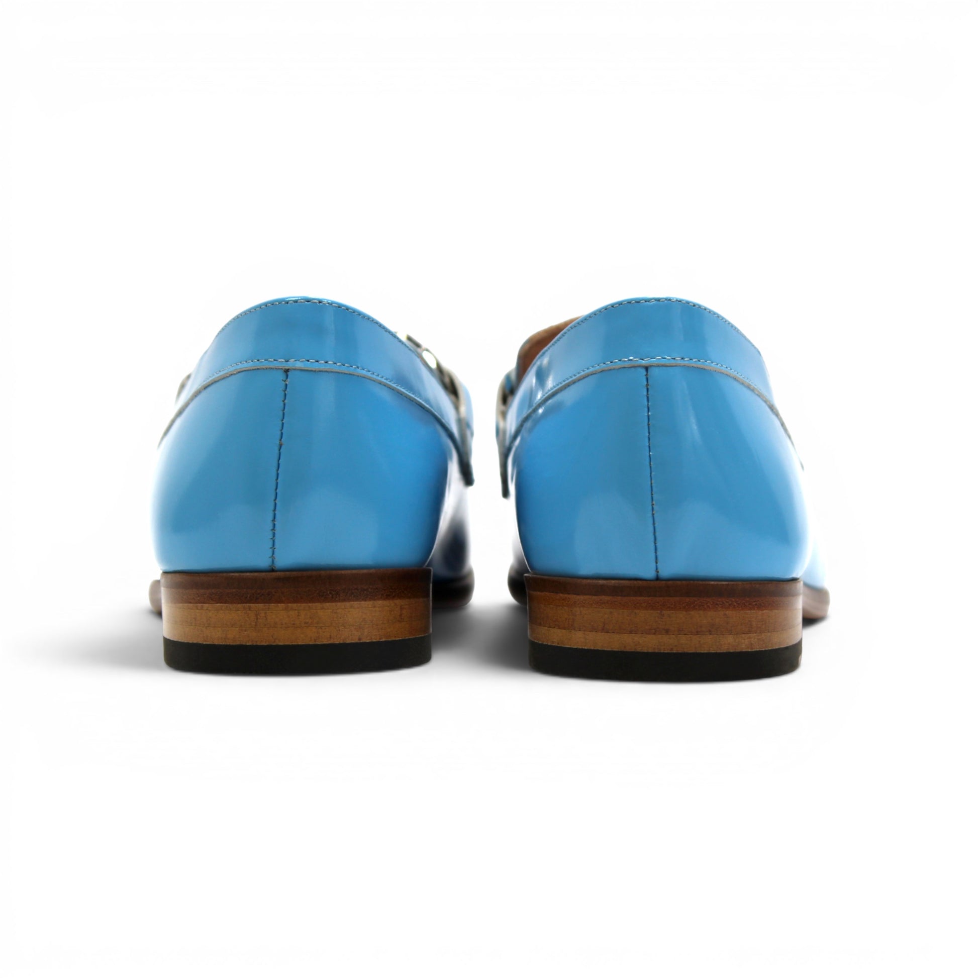 The Emilio Franco M2 Light Blue is a shiny light blue genuine leather loafer by Emilio Franco, featuring a silver decorative buckle on top and a classic leather sole, displayed on a flat white background.
