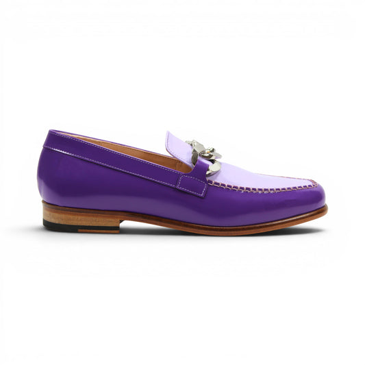 The Emilio Franco M2 Purple/Lavender loafer is an Italian-crafted shoe featuring white stitching, a metal chain detail on the upper, and a brown wooden sole.