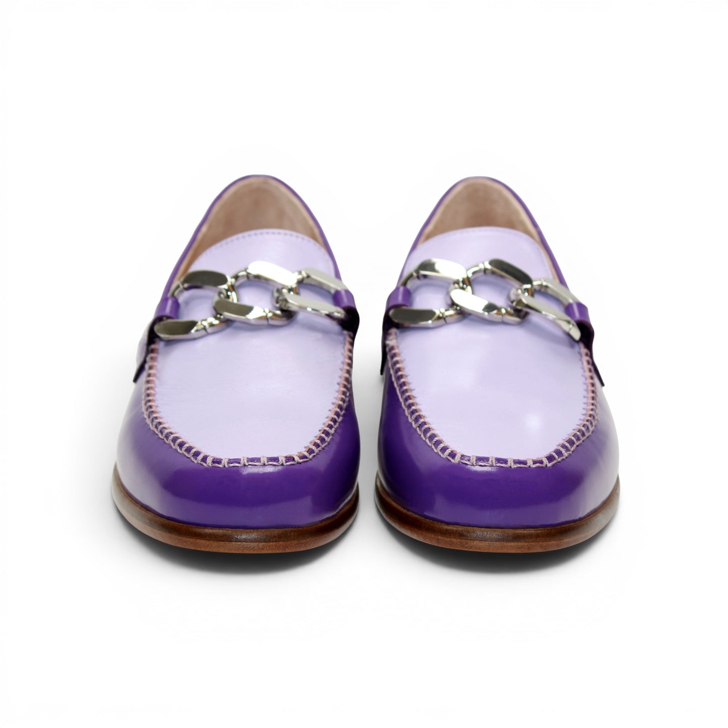 The Emilio Franco M2 Purple/Lavender loafer is an Italian-crafted shoe featuring white stitching, a metal chain detail on the upper, and a brown wooden sole.