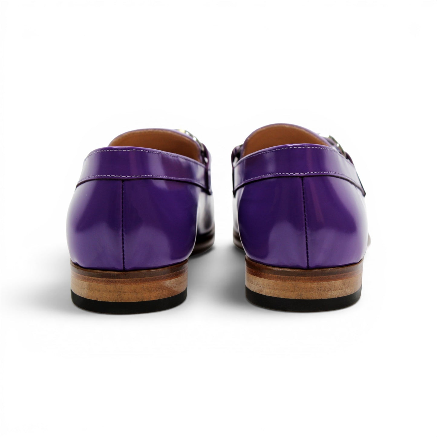 The Emilio Franco M2 Purple/Lavender loafer is an Italian-crafted shoe featuring white stitching, a metal chain detail on the upper, and a brown wooden sole.