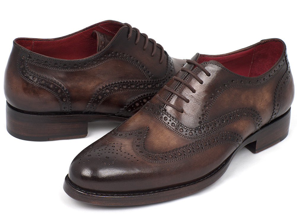 The Paul Parkman Wingtip Oxfords Goodyear Welted Brown - 027-BRW are men's handmade brown leather brogue dress shoes with decorative perforations, displayed against a white background.