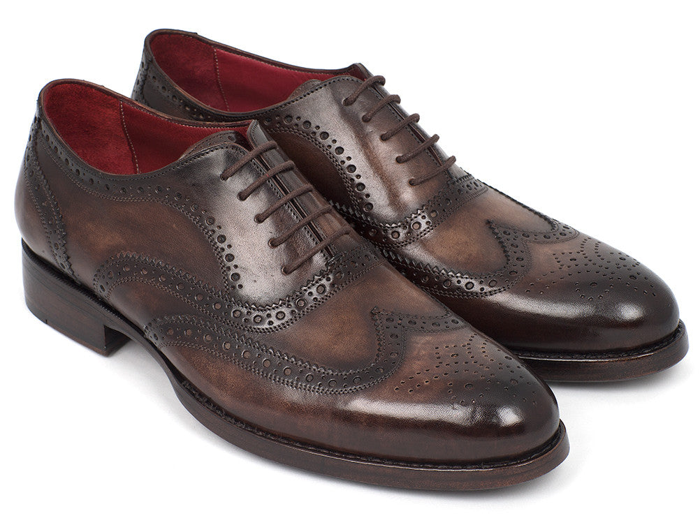 The Paul Parkman Wingtip Oxfords Goodyear Welted Brown - 027-BRW are men's handmade brown leather brogue dress shoes with decorative perforations, displayed against a white background.