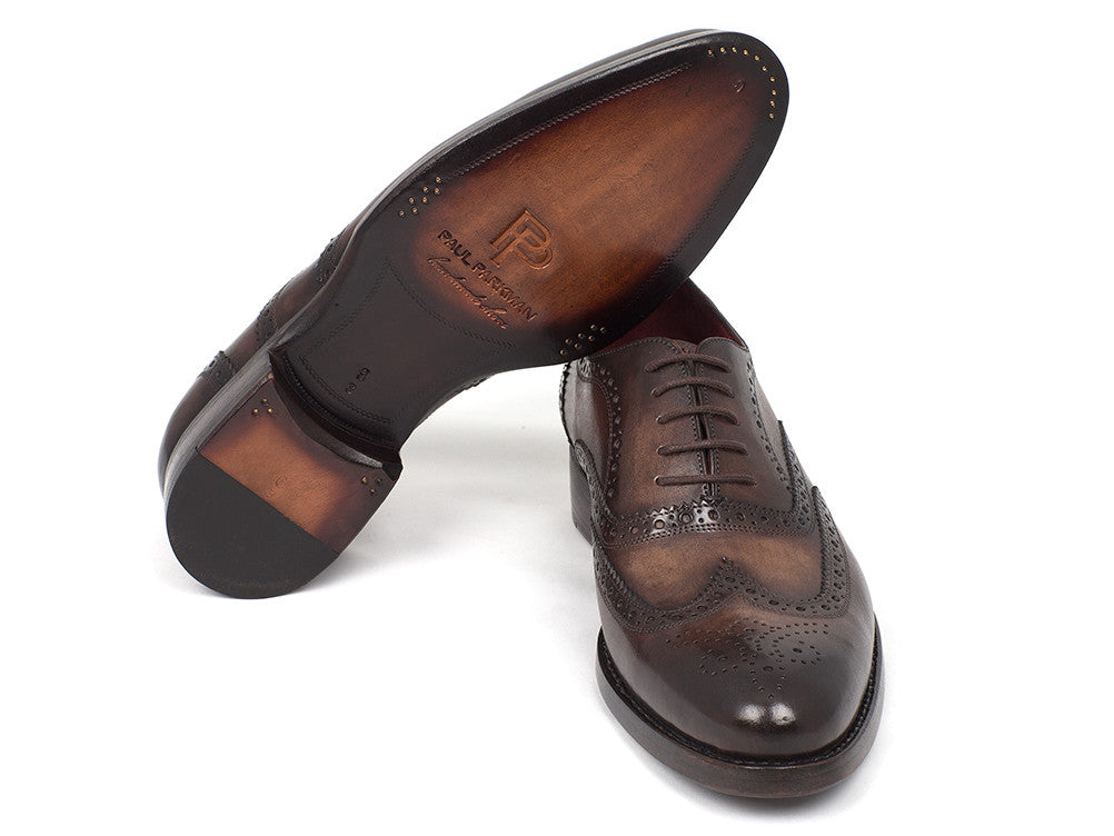 The Paul Parkman Wingtip Oxfords Goodyear Welted Brown - 027-BRW are men's handmade brown leather brogue dress shoes with decorative perforations, displayed against a white background.