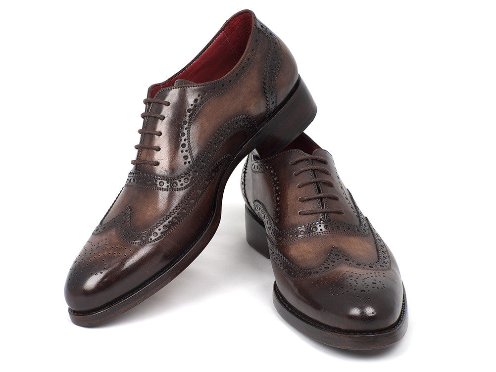 The Paul Parkman Wingtip Oxfords Goodyear Welted Brown - 027-BRW are men's handmade brown leather brogue dress shoes with decorative perforations, displayed against a white background.