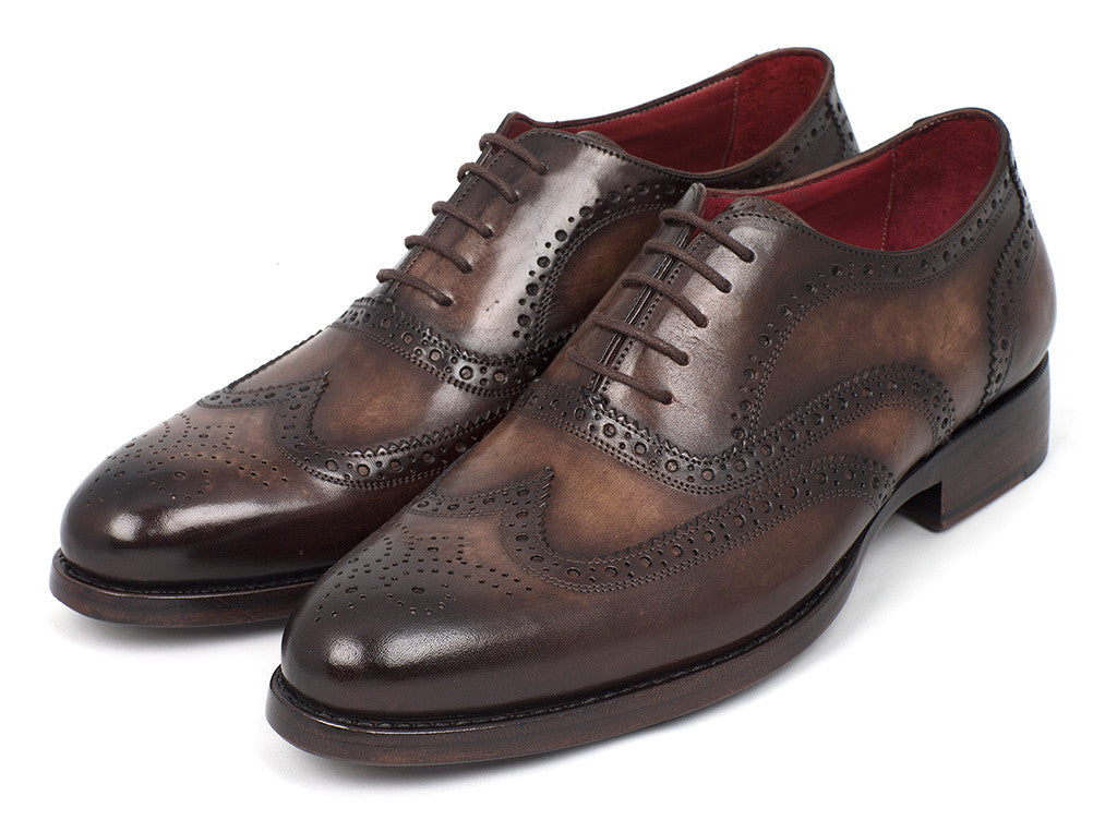 The Paul Parkman Wingtip Oxfords Goodyear Welted Brown - 027-BRW are men's handmade brown leather brogue dress shoes with decorative perforations, displayed against a white background.