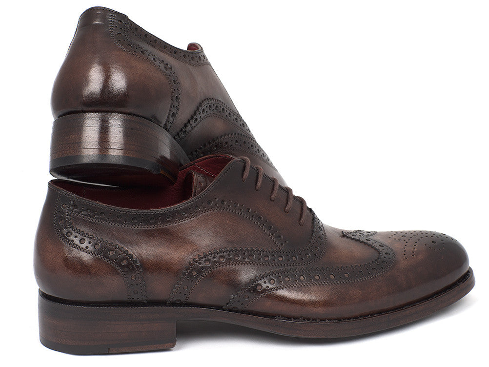 The Paul Parkman Wingtip Oxfords Goodyear Welted Brown - 027-BRW are men's handmade brown leather brogue dress shoes with decorative perforations, displayed against a white background.