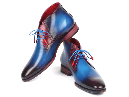 A pair of elegant, made-to-order Paul Parkman Chukka Boots in blue and purple with red accents and blue laces, expertly crafted from hand-painted calfskin, posed on a white background.