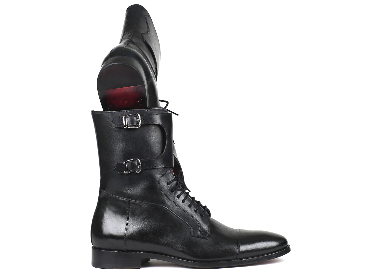 A pair of Paul Parkman High Boots Black Calfskin (F555-BLK) are shown, one upright and one propped horizontally. Both have a slight sheen, black hand-painted finish, cap-toe design, and visible red lining inside.