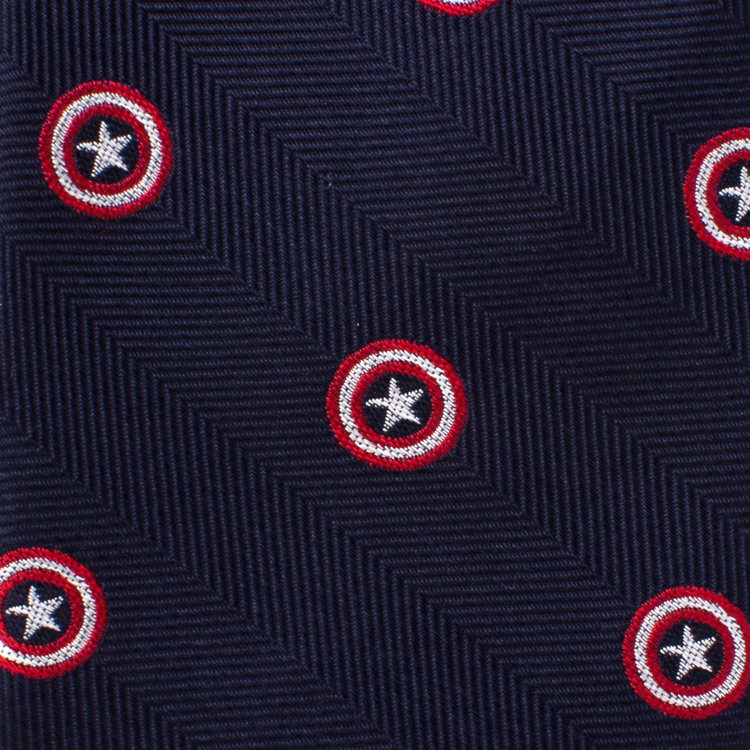 The Marvel Captain America Navy Tie from Cufflinks.com features a dark blue silk herringbone pattern decorated with small red and white outlined star emblems—perfect for any Marvel fan seeking an elegant, heroic accessory.