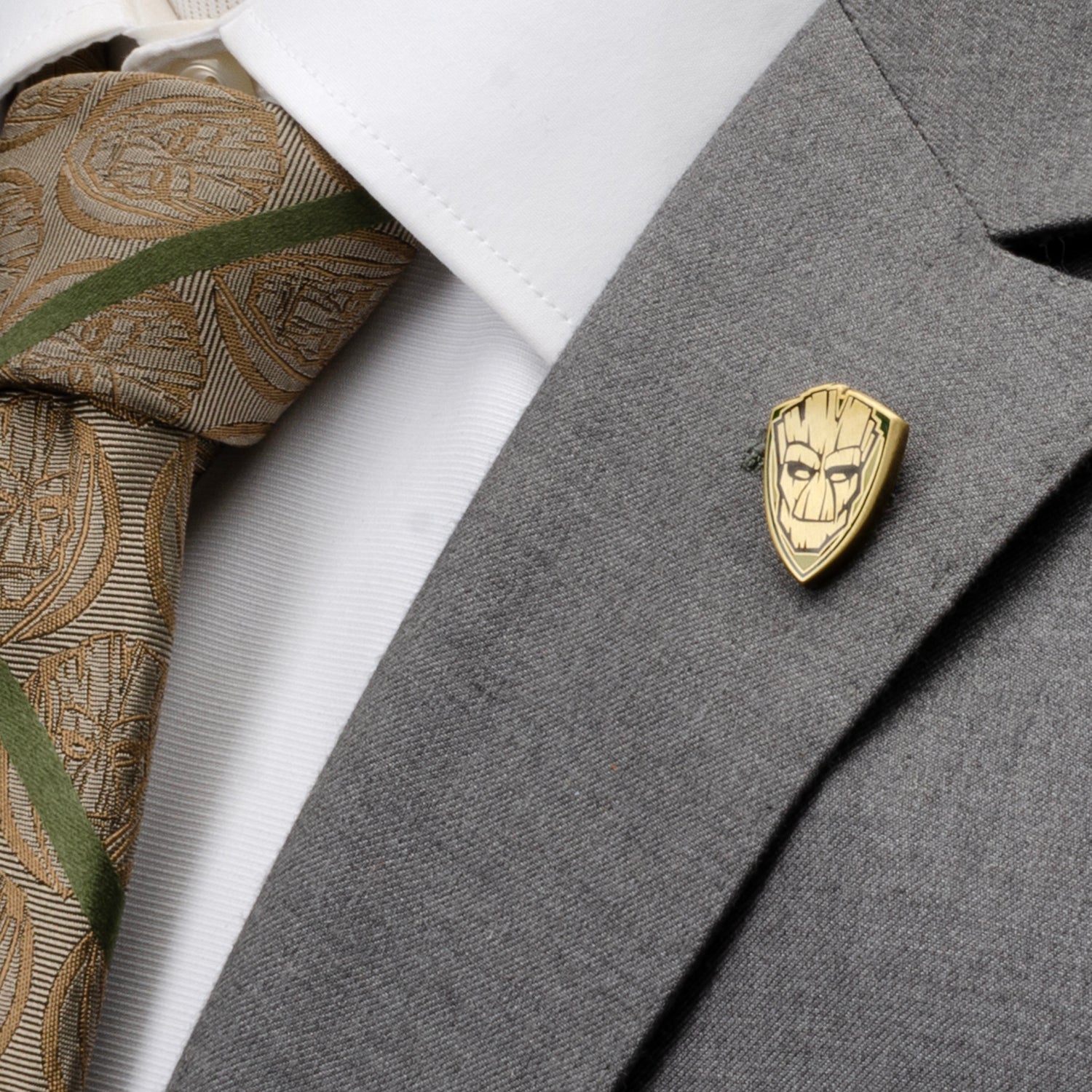 A pair of blue Guardians of the Galaxy Groot and Rocket argyle socks by Cufflinks.com, displayed next to a Marvel card with a gold mask, from the Marvel Groot Rocket Argyle Blue Gift Set.