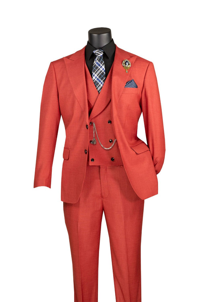 The Vinci Suits Modern Fit Brick Red 3 Piece Suit with Vest and Adjustable Waistband Pants MV2K-2 is displayed with a black shirt, plaid tie, pocket square, chain, and lapel pin.
