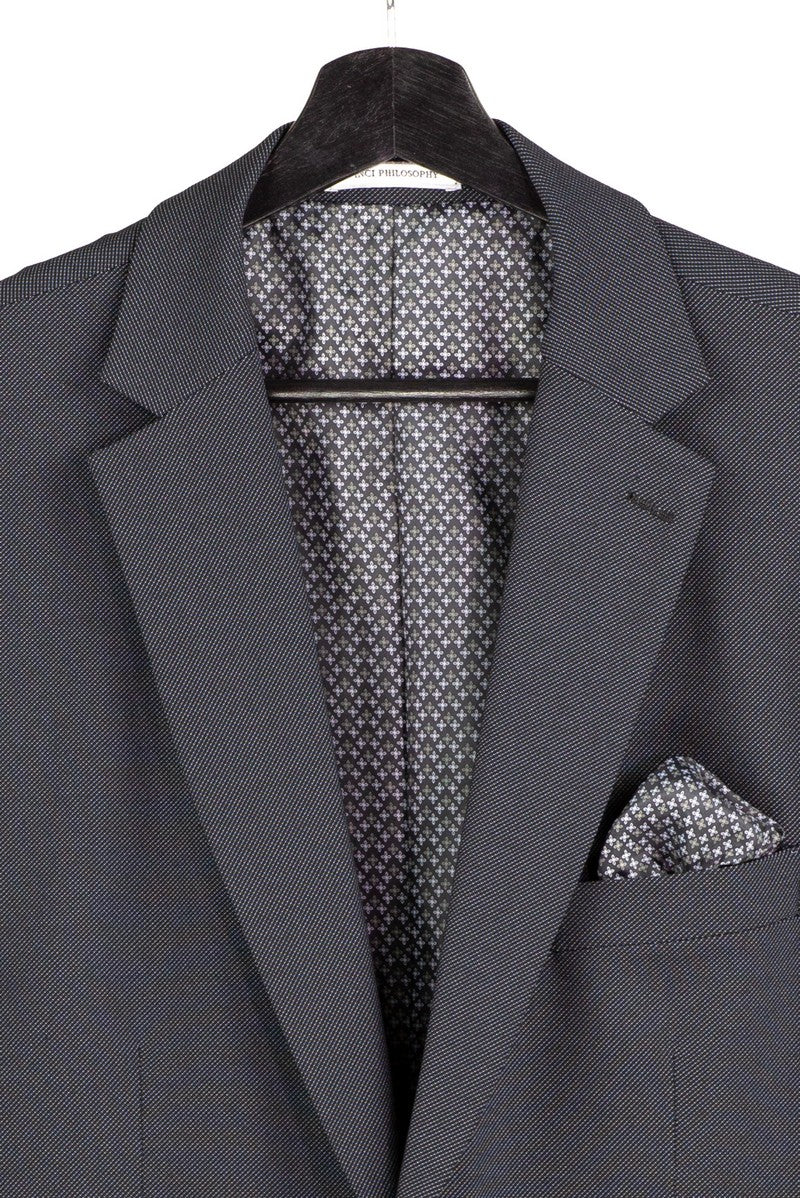 The Vinci Suits Modern Fit Charcoal Black 3 Piece Suit with Vest and Adjustable Waistband Pants MV2K-3 is shown styled with a white shirt, tan tie, pocket square, and vest chain on a mannequin.