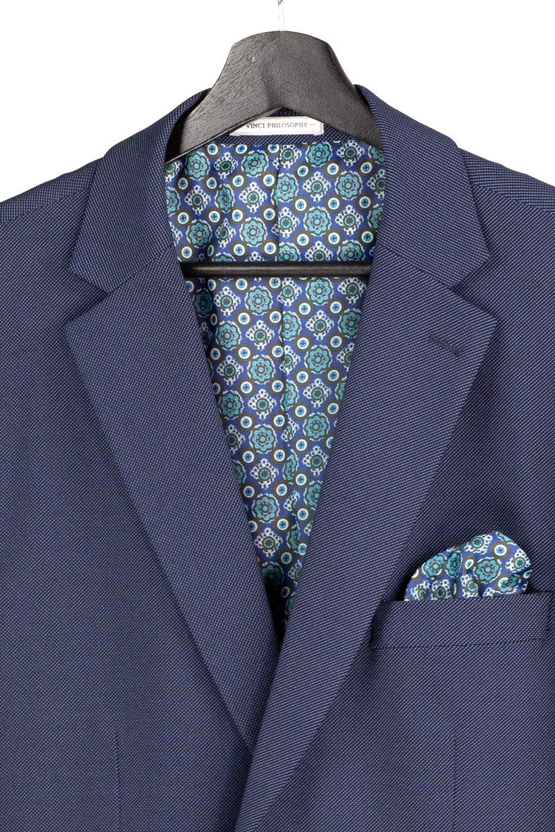 The Modern Fit Navy 3 Piece Suit with Vest and Adjustable Waistband Pants MV2K-3 by Vinci Suits is styled on a mannequin with white shirt, plaid tie, pocket square, and gold chain.