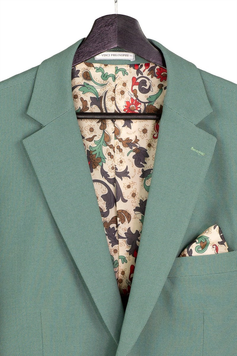 A mannequin displays the Modern Fit Sage 3 Piece Suit with Vest and Adjustable Waistband Pants MV2K-3 by Vinci Suits, paired with a light shirt, patterned tie, pocket square, and vest chain.