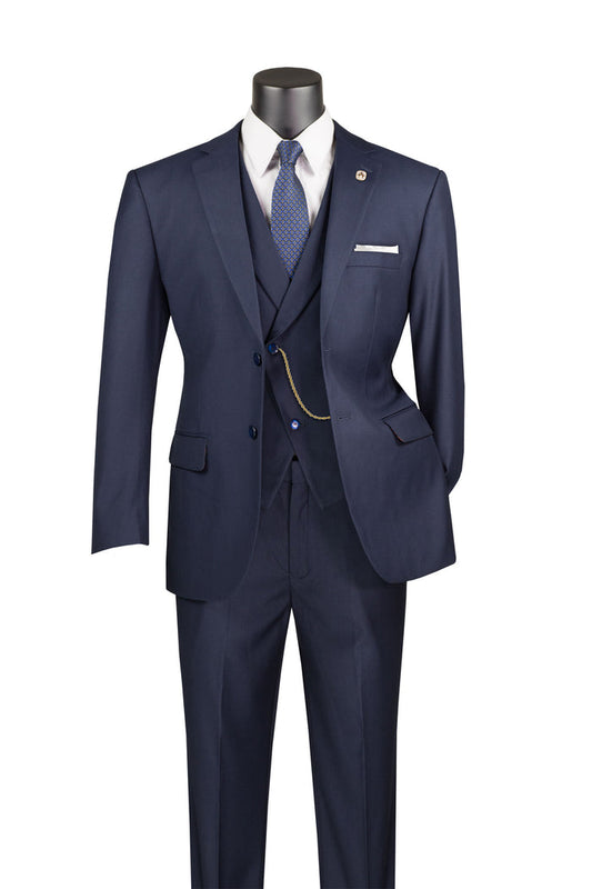 A mannequin displays the Vinci Suits Modern Fit 3 Piece Suit with Vest and Elastic Waist Band Pants (Navy) MV2TR, accompanied by a white shirt, blue tie, and pocket watch chain against a white background.
