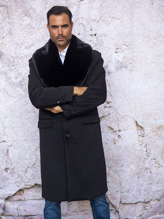 A man in an Insomnia MANZINI MZW-321 Black 3/4 Faux Fur Collar Winter Coat stands against a textured, off-white wall.