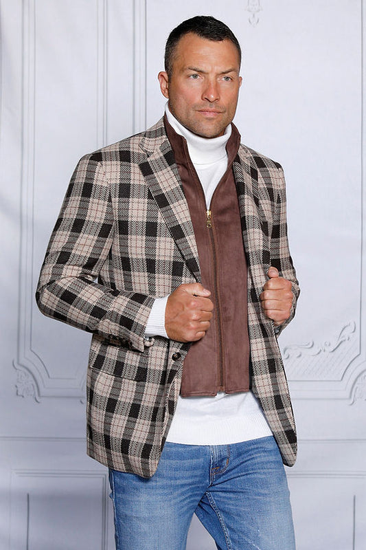 A man wearing the Insomnia MANZINI MZW-536 brown tailored fit faux wool plaid blazer coat with a zip-out liner and a white turtleneck is paired with blue jeans, standing against a light gray, textured backdrop.