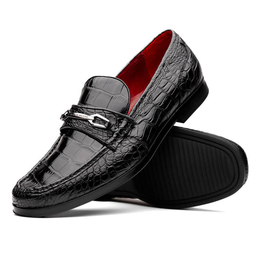 The Milan Black by Marco Di Milano is a black crocodile-pattern leather loafer with a metallic logo detail on the strap and red interior lining, epitomizing luxury men’s footwear.