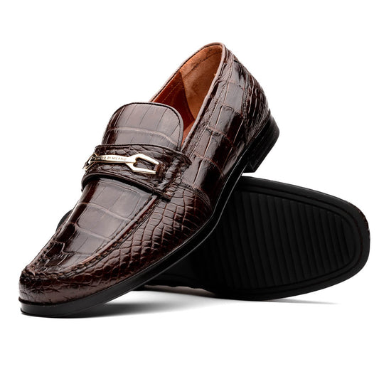 A pair of Marco Di Milano "Milan Brown" luxury loafers featuring brown crocodile-pattern leather and a metal buckle; one shoe is upright while the other is on its side, displaying the sole.