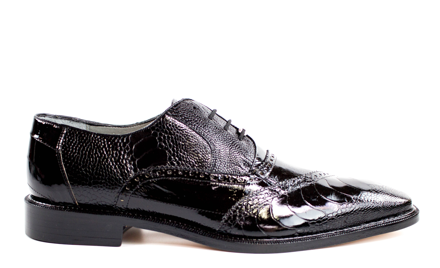 The BELVEDERE Nino dress shoe in black features genuine ostrich leg and eel leather, brogue detailing, a pointed toe, and low heel. Shown from the side on a white background.