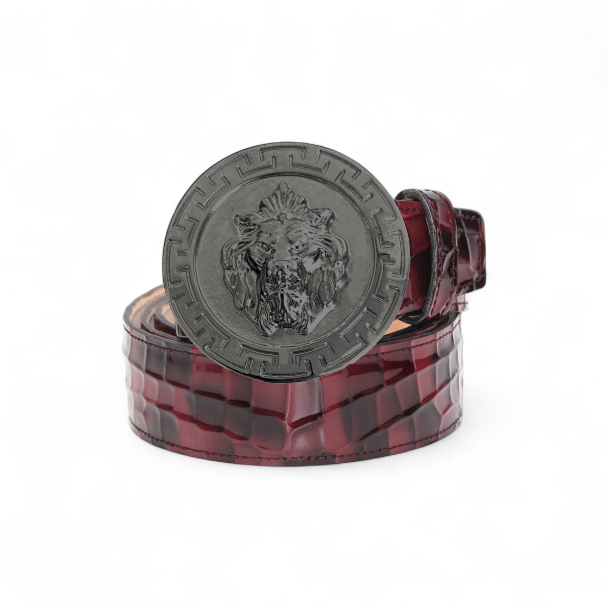 The Matiste Burgundy Leather Belt NS1 by Matiste features a maroon crocodile-patterned Italian leather and a bold metallic buckle with a raised lion head, bringing luxurious style to any outfit.