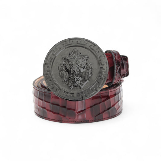 The Matiste Burgundy Leather Belt NS1 by Matiste features a maroon crocodile-patterned Italian leather and a bold metallic buckle with a raised lion head, bringing luxurious style to any outfit.