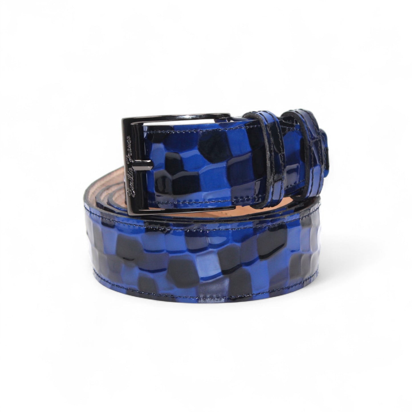 The Matiste Navy Leather Belt NS1 by Matiste features textured blue leather and a bold round metallic buckle with a lion head design.